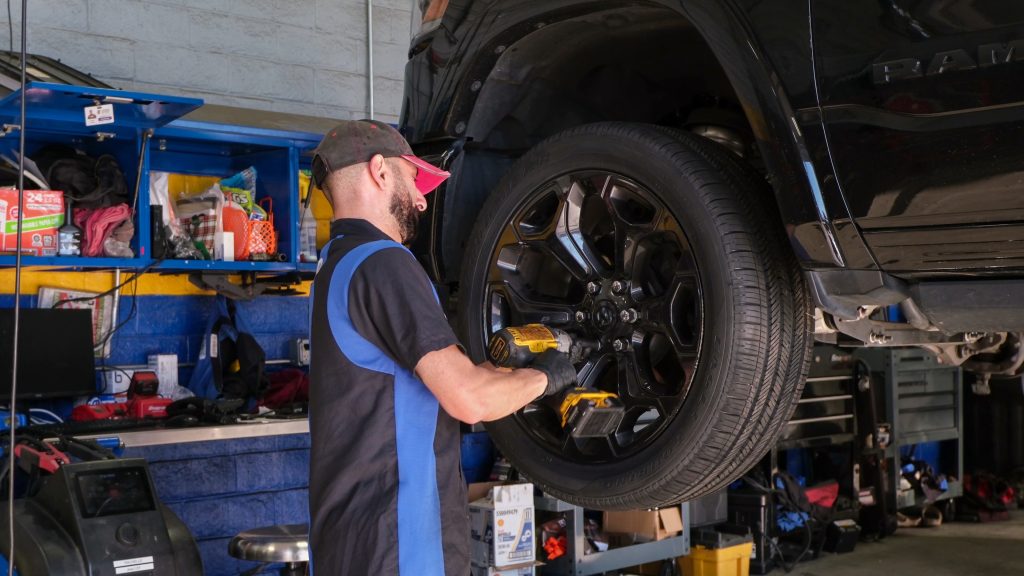 Certified Mopar® Service at Tustin Chrysler Dodge Jeep Ram Certified Chrysler Dodge Jeep Ram technician performing wheel service in Tustin CDJR service bay